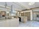 Bright open kitchen with brick accents, granite counters, and modern appliances create a welcoming space at 3042 Oak Creek N Dr, Clearwater, FL 33761