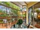 Comfortable back deck with covered area, seating, and a peaceful view of the surrounding greenery at 3484 Primrose Way, Palm Harbor, FL 34683