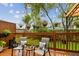 Comfortable back deck with seating, greenery, and privacy fence at 3484 Primrose Way, Palm Harbor, FL 34683