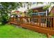 Backyard patio with lounge chairs and hanging flower baskets surrounded by grass at 3484 Primrose Way, Palm Harbor, FL 34683