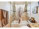 Cozy bathroom featuring a shower-tub combo, decorative shower curtain, and tiled walls for a spa-like experience at 3484 Primrose Way, Palm Harbor, FL 34683