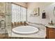 Relaxing bathroom featuring a soaking tub, glass shower, and neutral colors create a serene and inviting space at 3484 Primrose Way, Palm Harbor, FL 34683