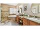 Bathroom featuring double sinks, granite countertops, a soaking tub and a tiled shower at 3484 Primrose Way, Palm Harbor, FL 34683