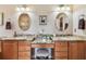 Charming bathroom featuring double sinks, vanity, granite counters, and mirrors, offering both style and functionality at 3484 Primrose Way, Palm Harbor, FL 34683