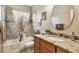 Stylish bathroom with granite countertop, decorative mirror, and tiled shower-tub combo at 3484 Primrose Way, Palm Harbor, FL 34683