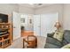 Spacious bedroom with open doorway, closet, sitting area and ceiling fan at 3484 Primrose Way, Palm Harbor, FL 34683