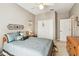 Comfortable bedroom featuring a well-made bed, ceiling fan, and ample closet space at 3484 Primrose Way, Palm Harbor, FL 34683