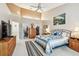 Bedroom featuring a bed, closet, and view to the bathroom and light-filled space at 3484 Primrose Way, Palm Harbor, FL 34683