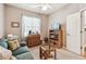 Bedroom features neutral color walls, carpet, ceiling fan, and a view of exterior at 3484 Primrose Way, Palm Harbor, FL 34683