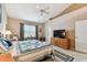 Bedroom with a queen-size bed, ceiling fan, and lots of natural light from the window at 3484 Primrose Way, Palm Harbor, FL 34683