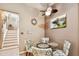 Cozy dining area with a glass table, four chairs, and a ceiling fan at 3484 Primrose Way, Palm Harbor, FL 34683