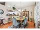 Charming dining area next to an open kitchen with hardwood floors and bright natural light at 3484 Primrose Way, Palm Harbor, FL 34683