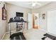 Neutral-toned exercise room featuring a treadmill, mounted TV, and doorway to another room at 3484 Primrose Way, Palm Harbor, FL 34683