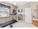 Bright exercise room equipped with a treadmill, TV, and window for natural light at 3484 Primrose Way, Palm Harbor, FL 34683