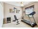 Home gym featuring a treadmill, weight bench, and sleek black mini-refrigerator for convenience at 3484 Primrose Way, Palm Harbor, FL 34683