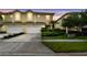 A charming townhouse with a two-car garage, lush landscaping, and a well-manicured lawn at 3484 Primrose Way, Palm Harbor, FL 34683