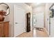 Foyer featuring tile floors, an antique clock, and ample natural light from the front door at 3484 Primrose Way, Palm Harbor, FL 34683