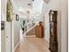 Inviting foyer with tile flooring, a staircase, and a vintage grandfather clock at 3484 Primrose Way, Palm Harbor, FL 34683