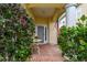 Cozy front porch with a decorative table, blooming flowers, and an American flag at 3484 Primrose Way, Palm Harbor, FL 34683