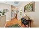 Hallway leading to bathroom and laundry room, adorned with a desk and artwork at 3484 Primrose Way, Palm Harbor, FL 34683
