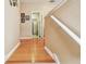 Hallway with hardwood floors leading to laundry room; features wall decor at 3484 Primrose Way, Palm Harbor, FL 34683