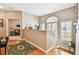 Hallway featuring wood floors, an arched window and staircase with white railing at 3484 Primrose Way, Palm Harbor, FL 34683