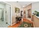 Inviting hallway with hardwood floors, soft neutral colors, and multiple rooms branching off at 3484 Primrose Way, Palm Harbor, FL 34683