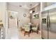 Quaint eat-in kitchen nook is adjacent to the home's stairway and features a stainless fridge at 3484 Primrose Way, Palm Harbor, FL 34683