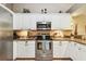 Well-lit kitchen featuring stainless steel appliances, granite countertops, and white cabinetry at 3484 Primrose Way, Palm Harbor, FL 34683