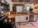 Kitchen featuring stainless steel appliances, granite countertops, and a view into the dining area at 3484 Primrose Way, Palm Harbor, FL 34683