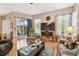Open-concept living area with hardwood floors, access to patio, and comfortable furniture at 3484 Primrose Way, Palm Harbor, FL 34683