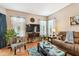 Comfortable living room with hardwood floors, stylish furnishings, and a large screen TV at 3484 Primrose Way, Palm Harbor, FL 34683