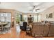 Bright and airy living room with hardwood floors, slider doors to a back patio, and comfortable seating at 3484 Primrose Way, Palm Harbor, FL 34683