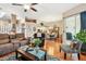 Open-concept living room flows to dining area with hardwood floors and access to the outdoor area at 3484 Primrose Way, Palm Harbor, FL 34683