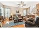 Inviting living room features hardwood floors, ceiling fan, and comfortable seating arrangement at 3484 Primrose Way, Palm Harbor, FL 34683