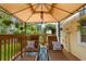 Relaxing covered patio with lounge chairs, an outdoor rug and beautiful green scenery at 3484 Primrose Way, Palm Harbor, FL 34683