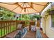 Relaxing covered patio with lounge chairs, an outdoor rug and beautiful green scenery at 3484 Primrose Way, Palm Harbor, FL 34683