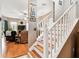 Bright foyer with a wooden staircase that leads to the second floor and a view of the living room at 3484 Primrose Way, Palm Harbor, FL 34683