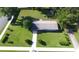 A bird's eye view shows the property with a sprawling green lawn and a quaint shed nestled in the back at 38320 14Th Ave, Zephyrhills, FL 33542