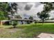 A serene backyard with a well-manicured lawn offers ample space for relaxation and outdoor activities at 38320 14Th Ave, Zephyrhills, FL 33542