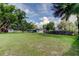 Sprawling backyard showcasing mature trees, lush grass, and a privacy fence, perfect for outdoor enjoyment at 38320 14Th Ave, Zephyrhills, FL 33542