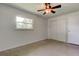 Bedroom featuring a ceiling fan, window and spacious closet at 38320 14Th Ave, Zephyrhills, FL 33542