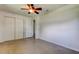Bedroom showcasing neutral walls, ceiling fan, and a double closet at 38320 14Th Ave, Zephyrhills, FL 33542