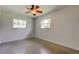 Bright bedroom with two windows, neutral walls, and ceiling fan at 38320 14Th Ave, Zephyrhills, FL 33542