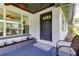 Cozy front porch featuring stylish outdoor seating, a welcoming entrance, and beautiful landscaping at 38320 14Th Ave, Zephyrhills, FL 33542
