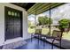 Inviting screened-in front porch with comfortable seating, offering a relaxing spot to enjoy the outdoors at 38320 14Th Ave, Zephyrhills, FL 33542