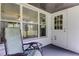 Cozy enclosed porch featuring a comfortable chair, table, and plenty of natural light at 38320 14Th Ave, Zephyrhills, FL 33542
