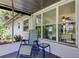 Charming enclosed porch with comfortable seating and lots of natural light at 38320 14Th Ave, Zephyrhills, FL 33542