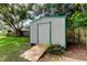 Durable storage shed with a ramp in a well-maintained backyard provides secure storage for your tools and equipment at 38320 14Th Ave, Zephyrhills, FL 33542