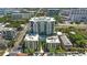 Aerial view of a high-rise condo featuring a rooftop pool, surrounded by lush greenery and city views at 400 4Th S Ave # 301, St Petersburg, FL 33701
